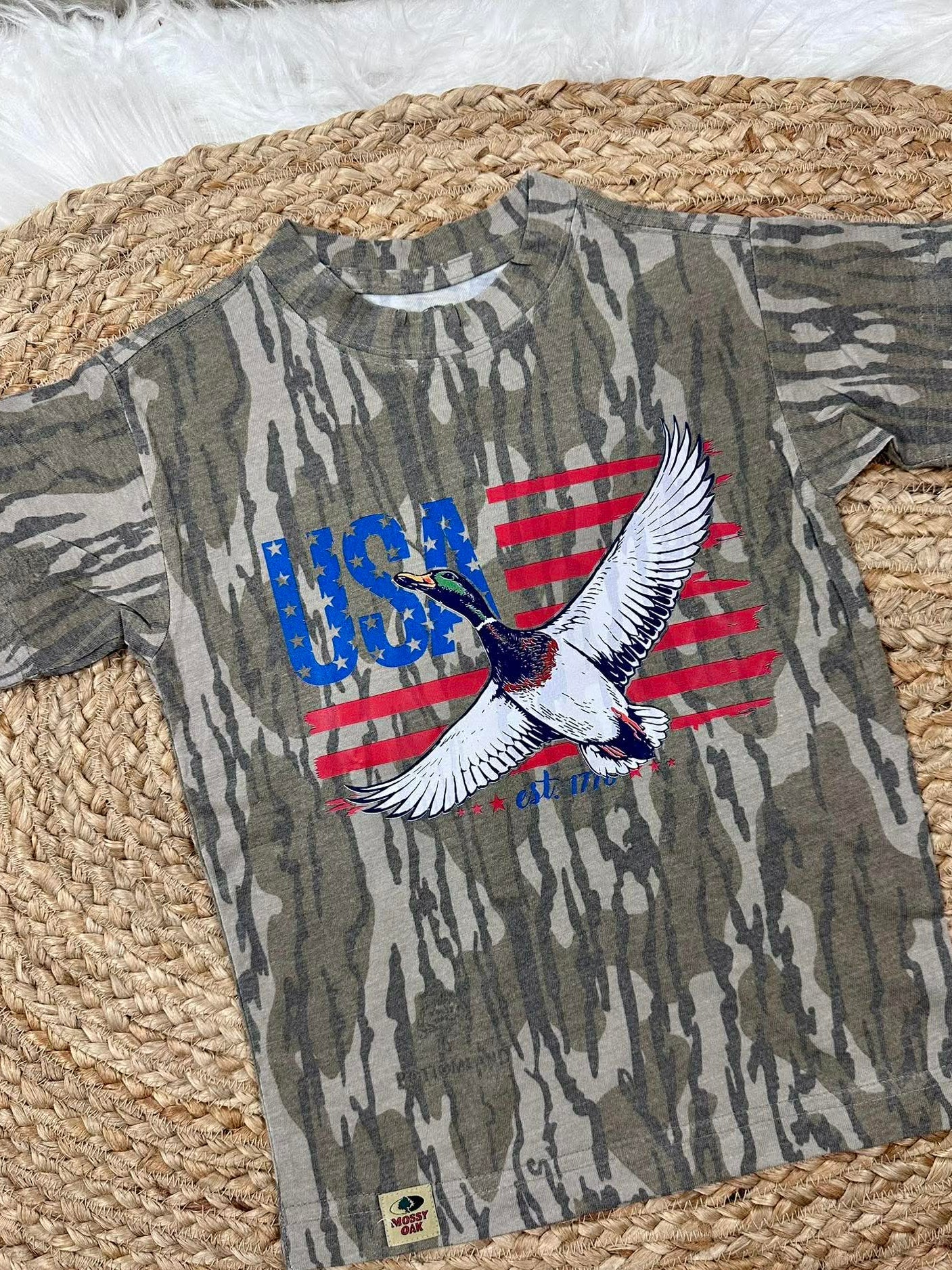 Camouflage t-shirt with USA and mallard duck like eagle design on a woven mat